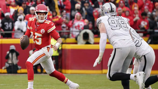 Kansas City Chiefs quarterback Patrick Mahomes is pursued by Las Vegas Raiders star Maxx Crosby.